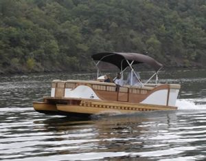 Pontoon boat with a canopy cruising on a lake