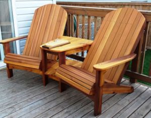 Double Adirondack chair with a center table on a deck