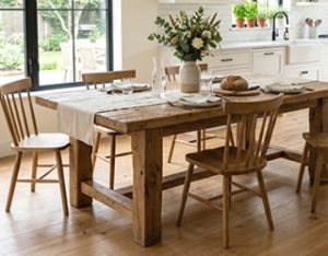 Farmhouse dining table with chairs in a bright kitchen