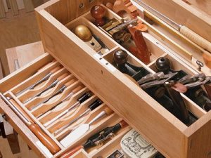 Wooden tool chest with chisels and hand planes
